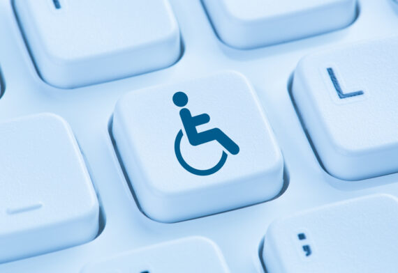 A keyboard key flashing a disability icon - an iconic representation of a person on a wheelchair.